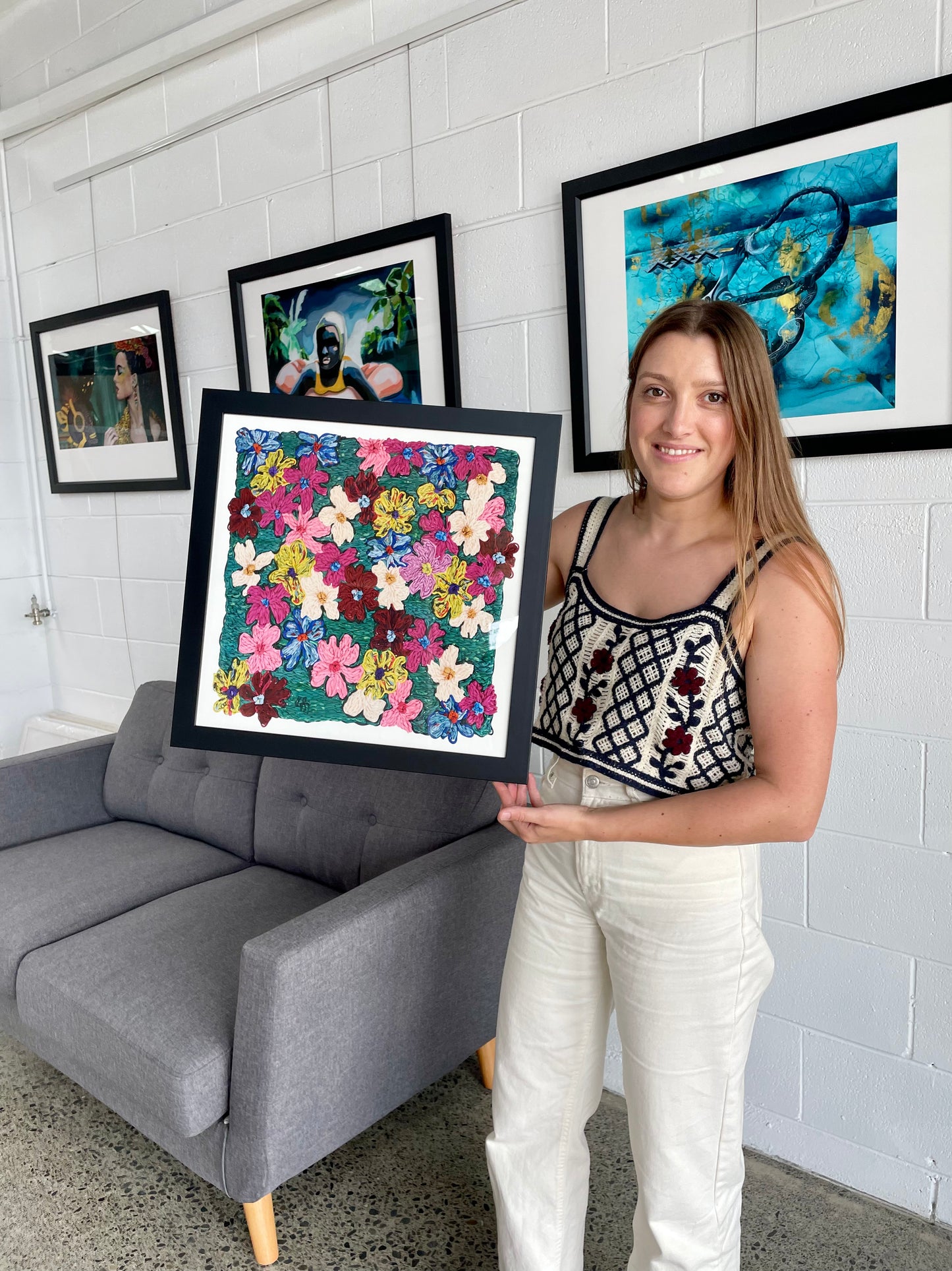 Vibrant floral embroidered artwork, bursting with colour and texture. Joyful artwork for my home. Frankie holding a beautiful art print.