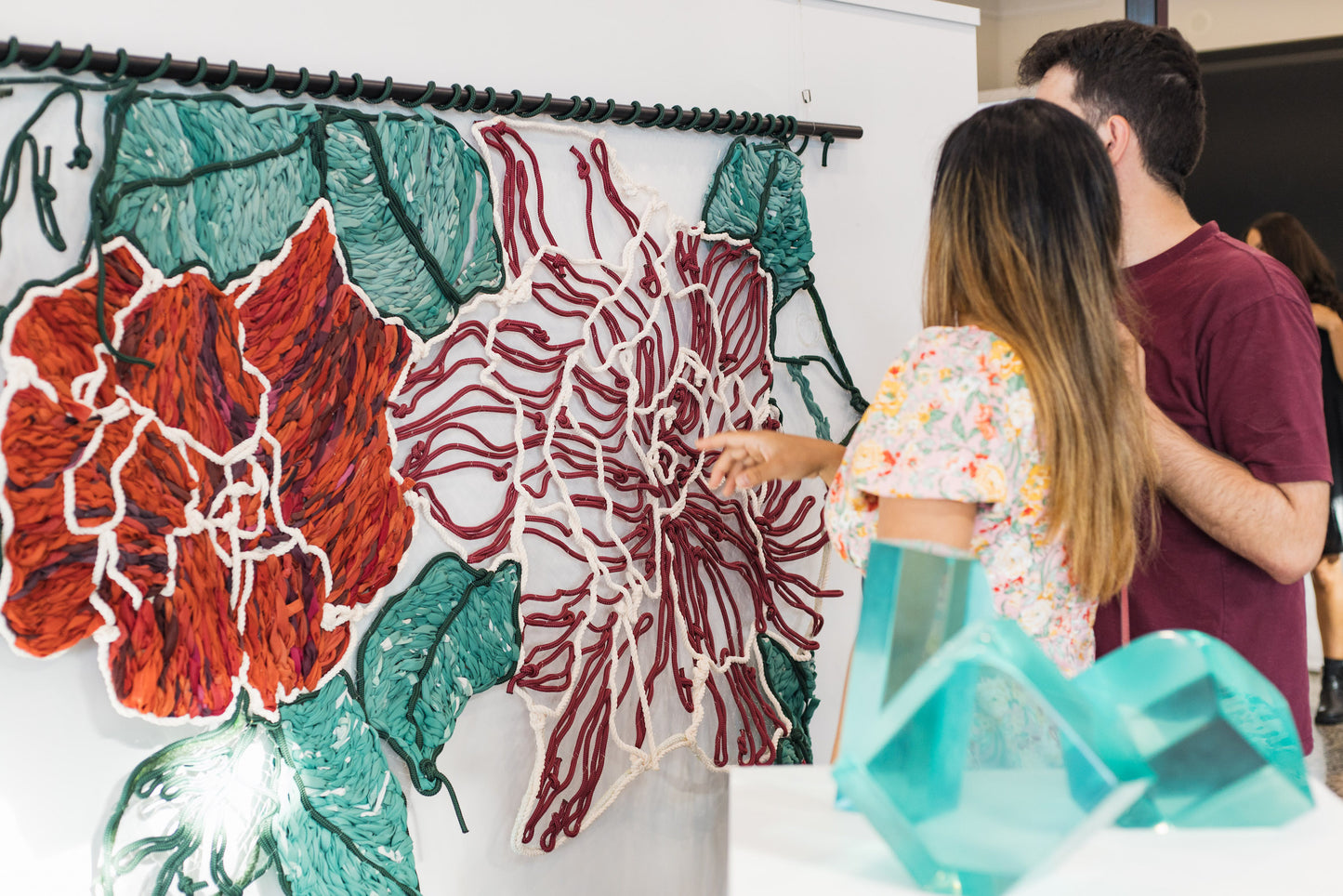 Giant embroidery made from colourful rope and discarded street banners