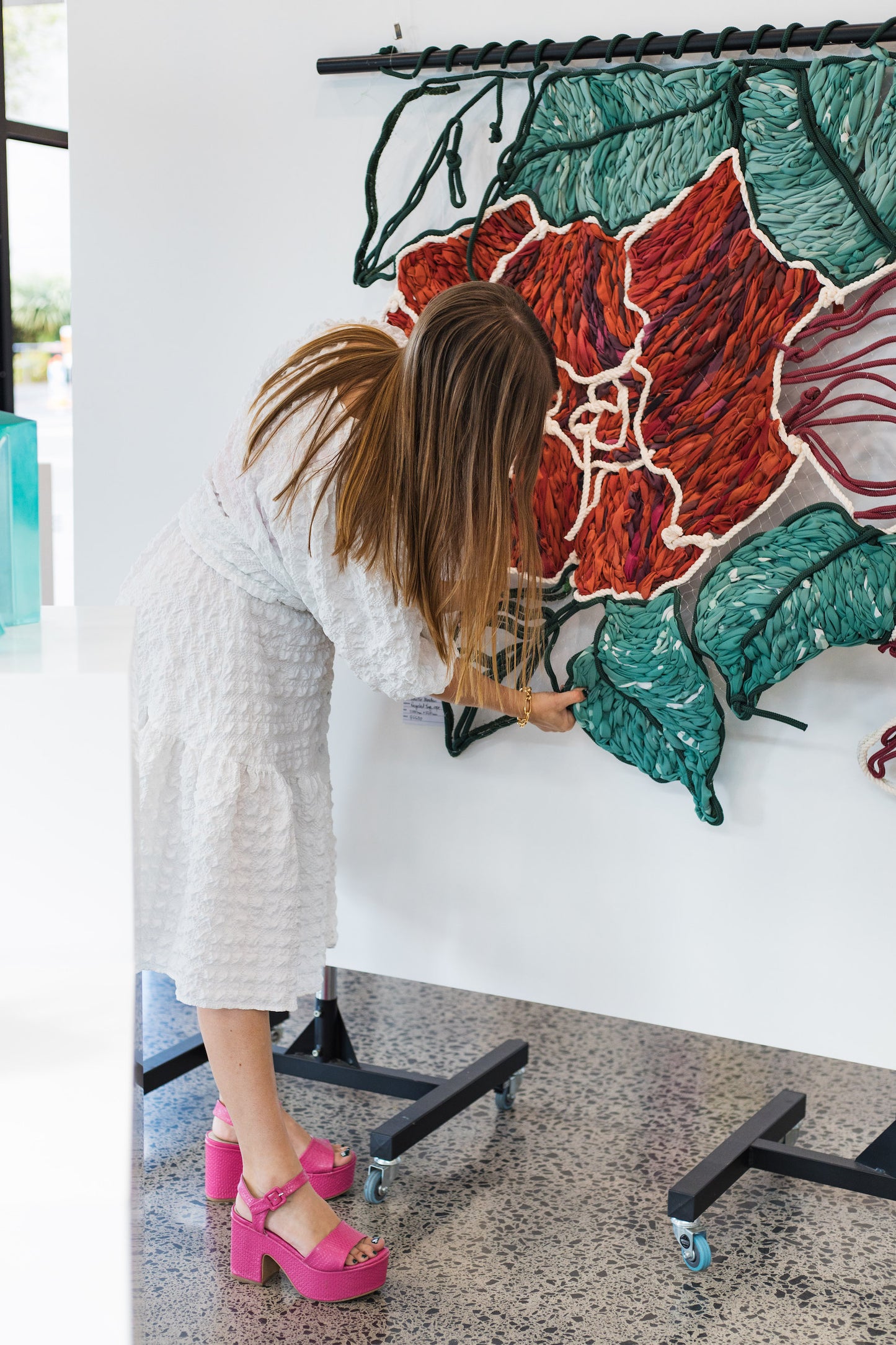 Giant embroidery made from colourful rope and discarded street banners