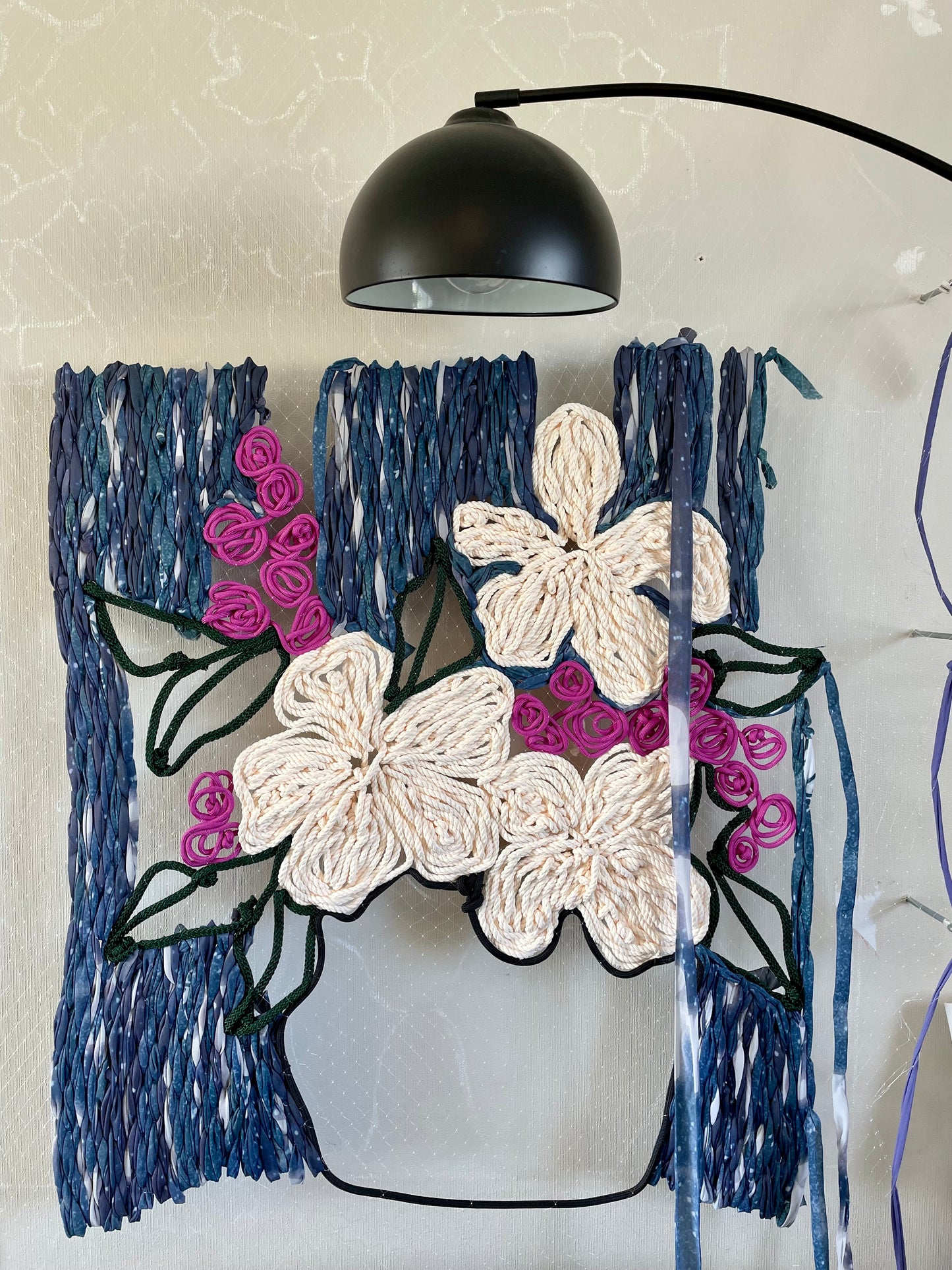 Half way throught the making process of the large floral tapestry art made from recycled materials