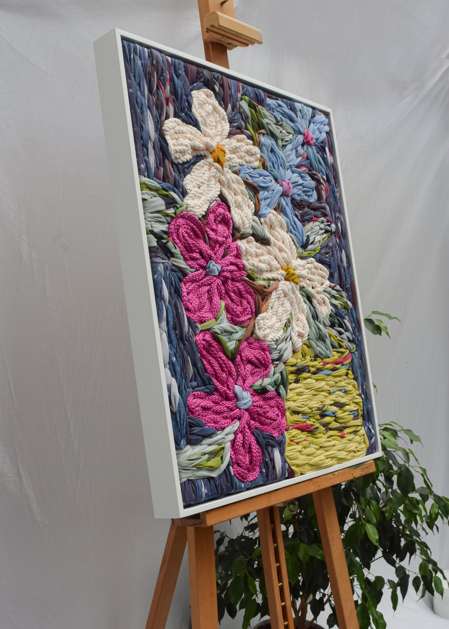 Botanical embroidery wall hanging featuring flowers styled in a vase by artist Frankie Meaden