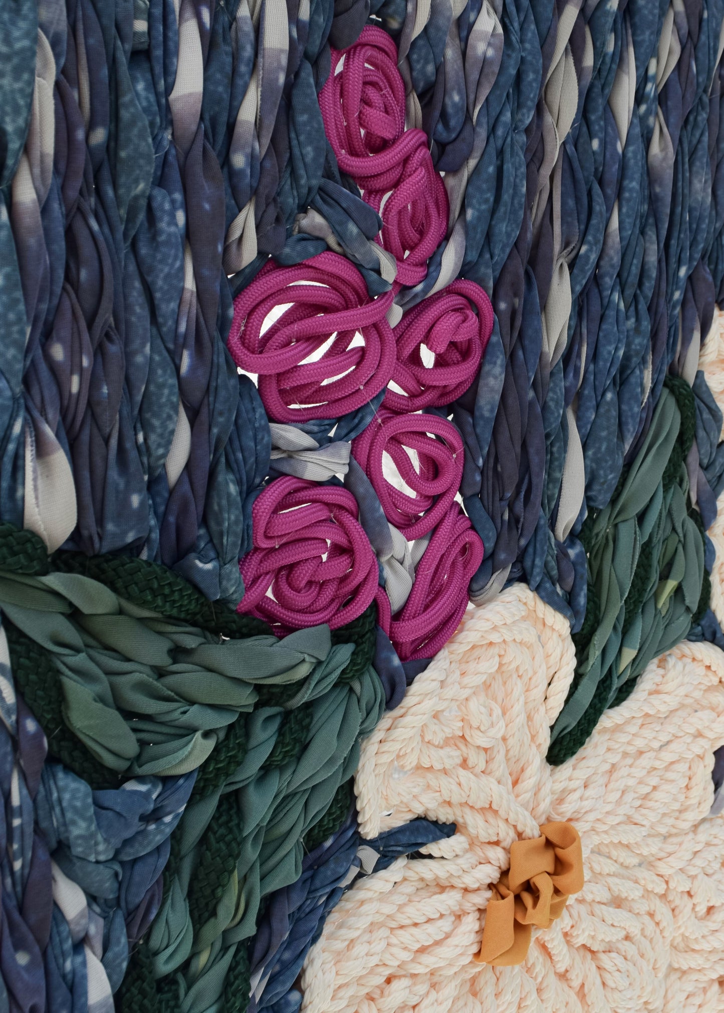 Detailed floral embroidery depicting flowers in a vase, statement wall art close up detail