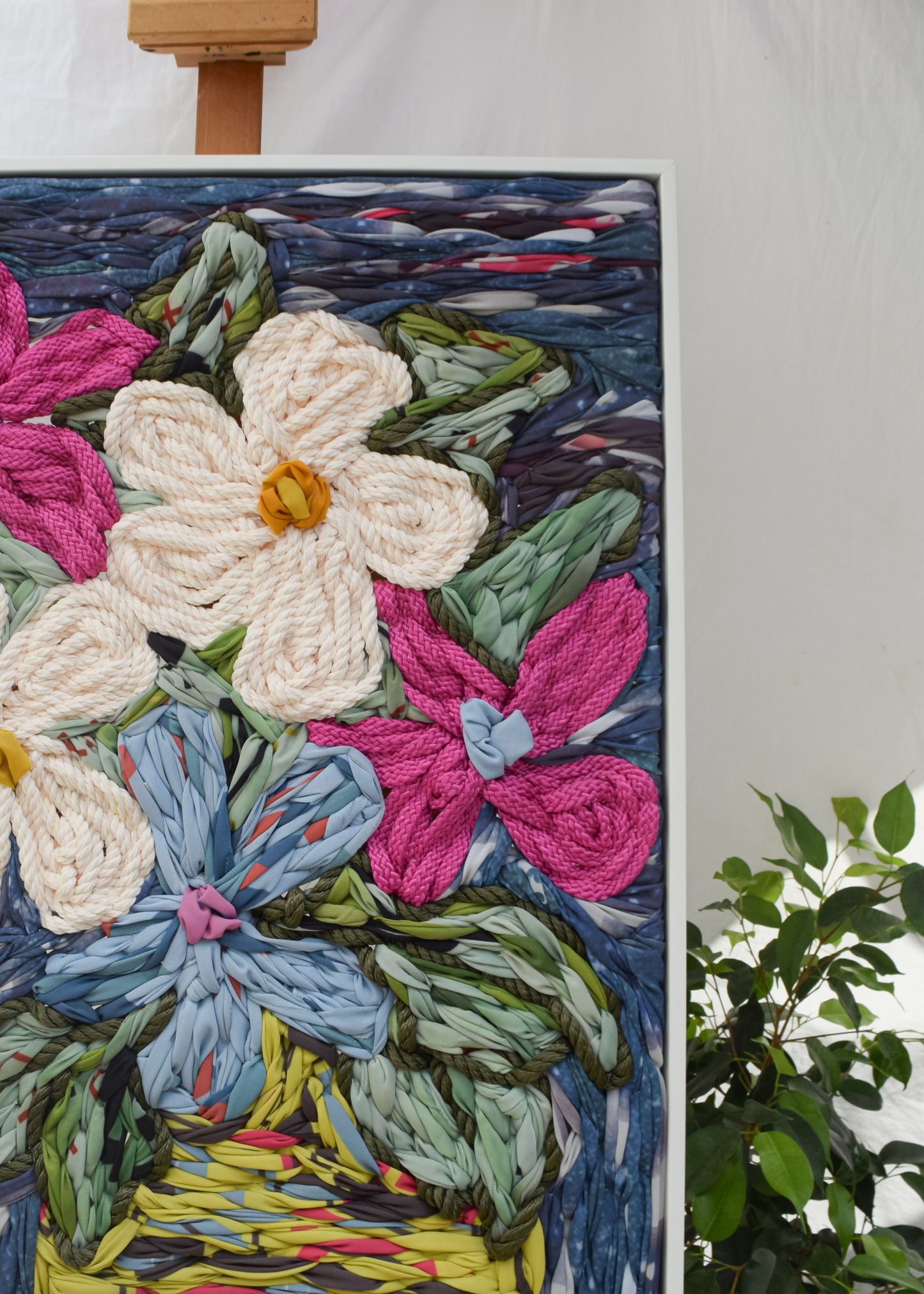 Botanical embroidery artwork featuring an oversized floral vase arrangement