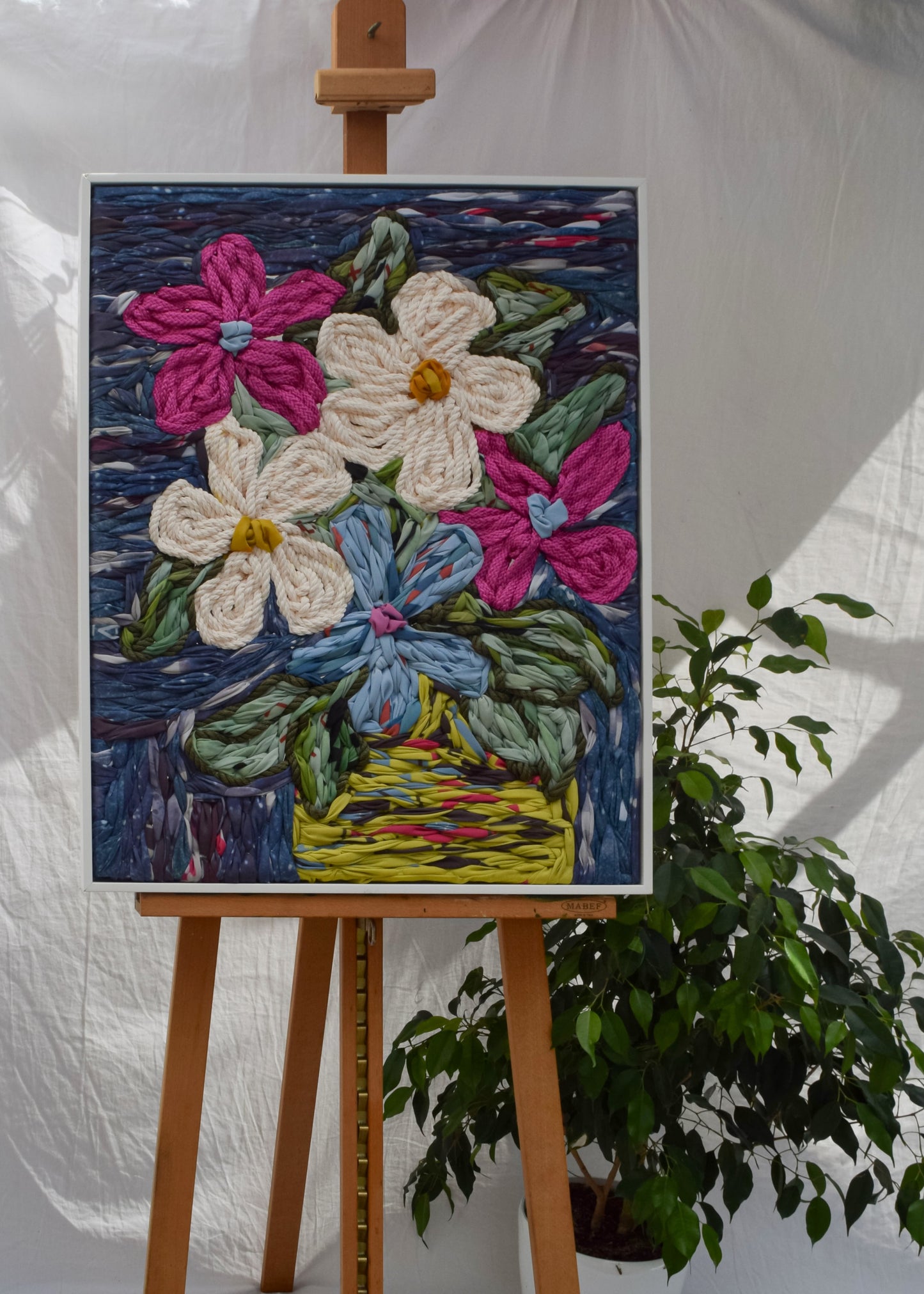 Oversized embroidery tapestry depicting flowers arranged in a vase