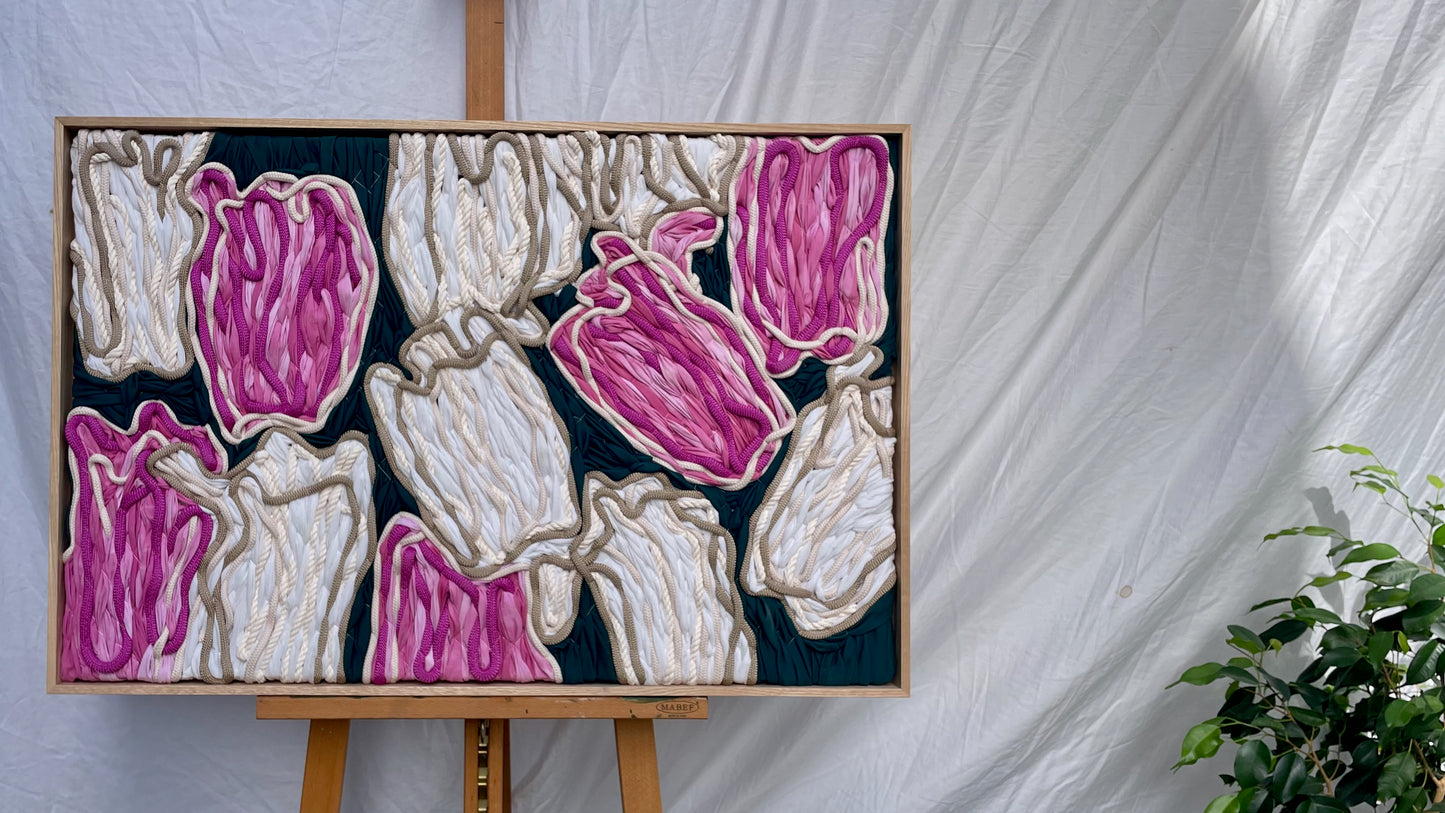 Framed floral embroidery tapestry featuring pink and cream tulips