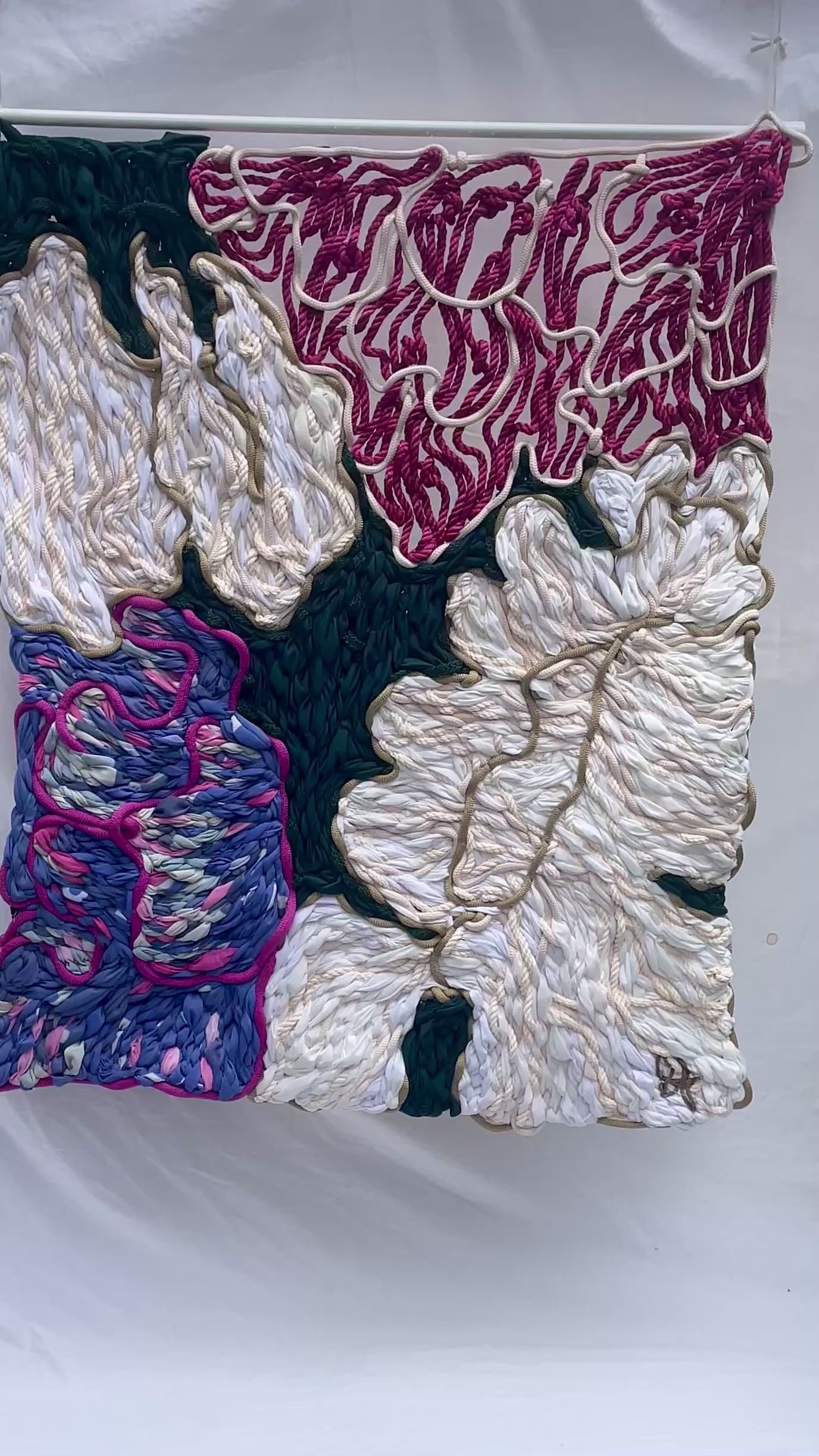 Close-up detail of hand stitched pink and cream peonies tapestry