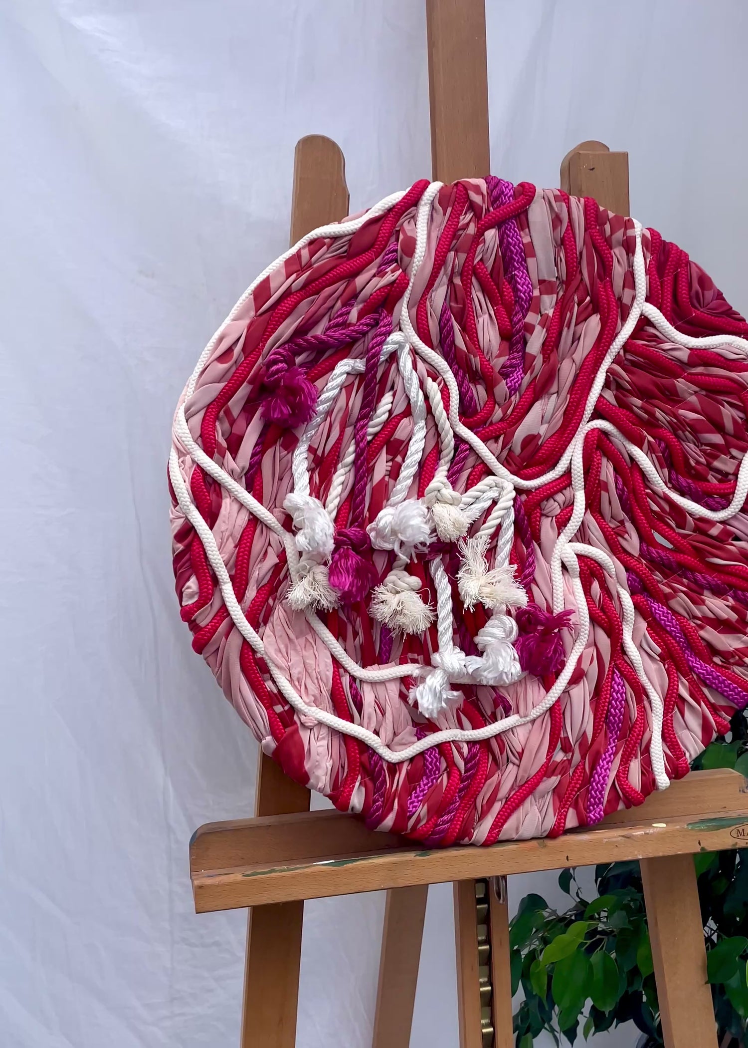 Abstract floral embroidery in rich red tones, large-scale wall art